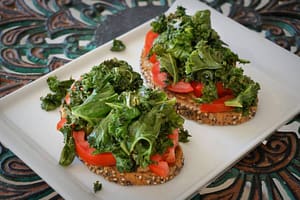 Vegan toasts with kale, tomato, tahin and rye bread