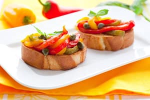 Bruschetta with roasted bell pepper, capers, and basil