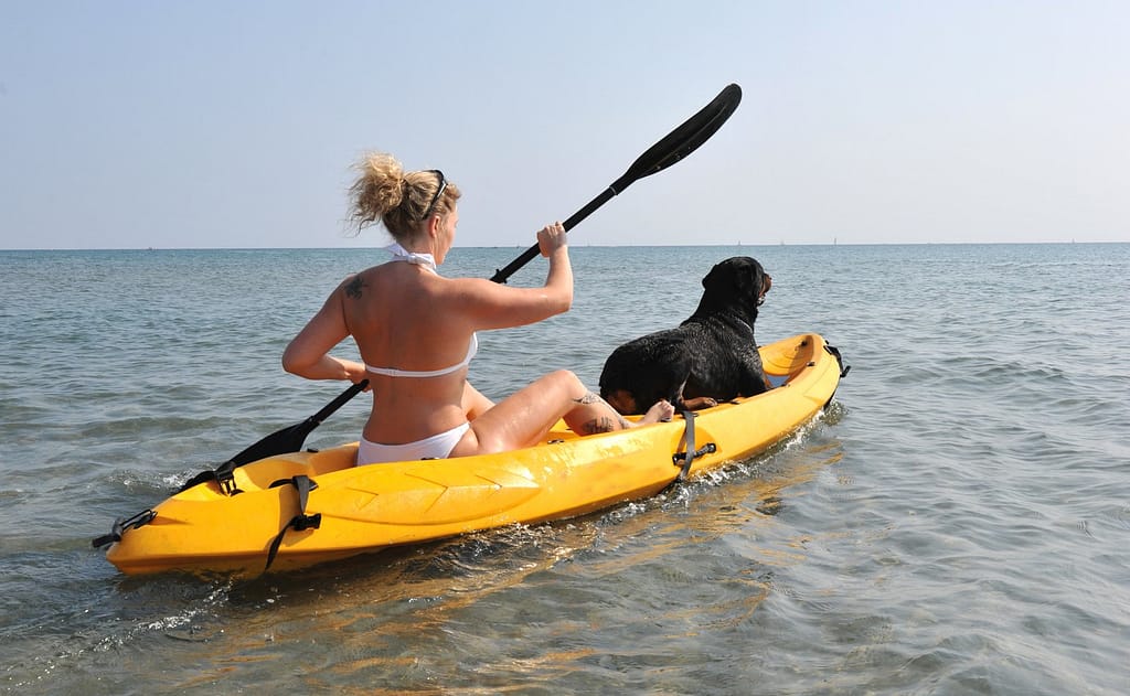 woman boating with canine