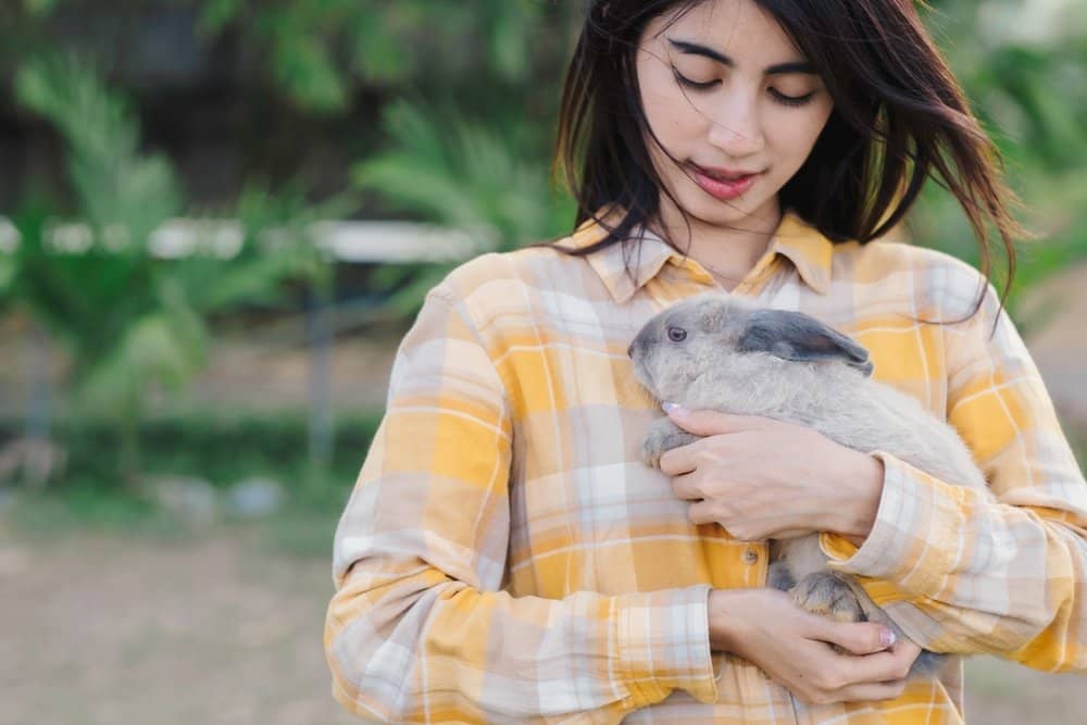 An owner carrying her bunny